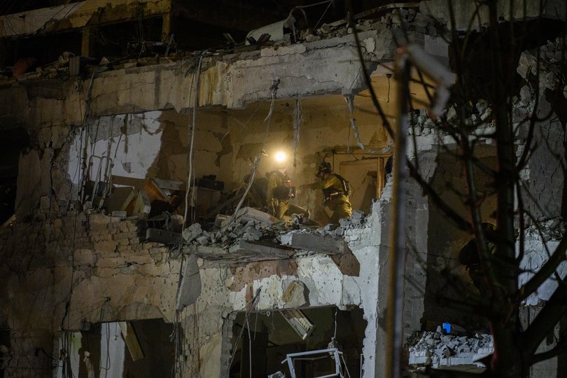  Emergency workers and security personnel clear the buildings damaged by a missile strike on February 28, 2026 in Tel Aviv, Israel. 