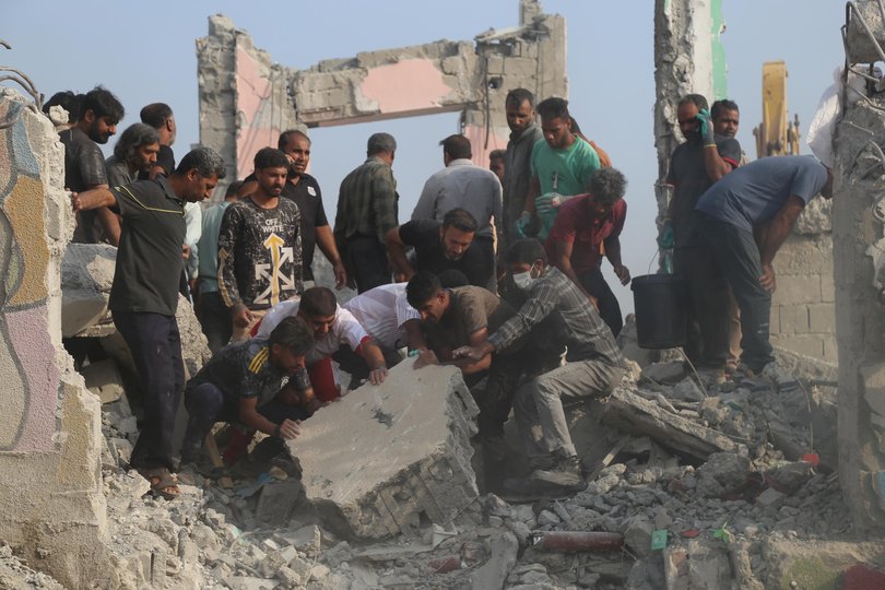Rescue workers and residents search through the rubble in the aftermath of an Israeli-U.S. strike on a girls' elementary school in Minab, Iran.