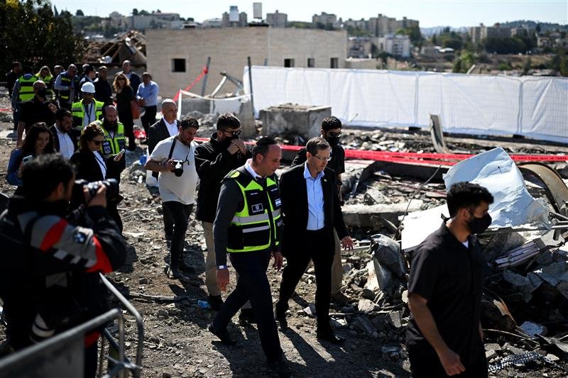 Israeli president Isaac Herzog visits a strike site in Israel on Monday.