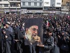 A man holds a portrait of Iran’s Supreme Leader Ayatollah Ali Khamenei as people mourn his death at a rally in Tehran.