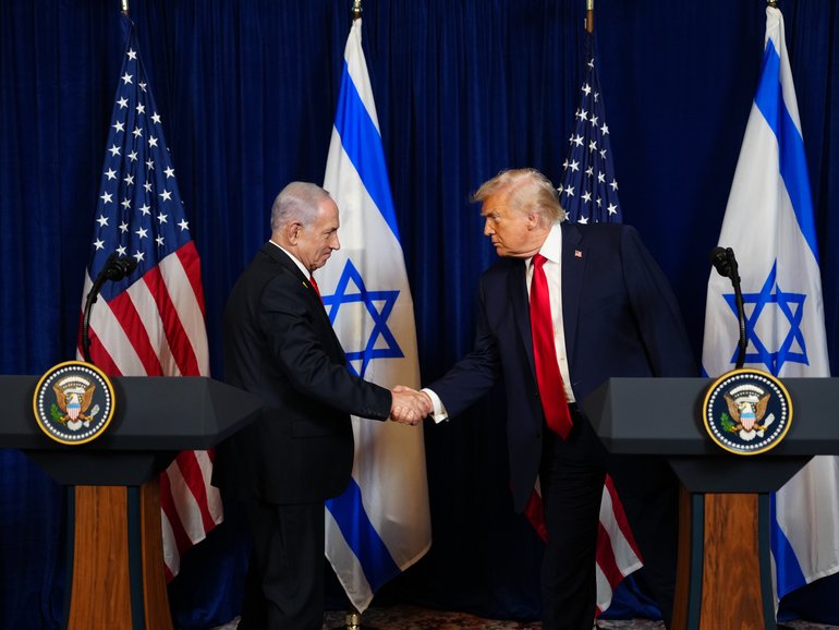 Benjamin Netanyahu and President Donald Trump shake hands during a joint news conference at Mar-a-Lago on December 29, 2025. 