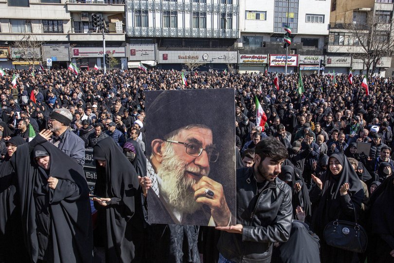 A man holds a portrait of IranÕs supreme leader, Ayatollah Ali Khamenei, as people mourn his killing at a rally in Tehran, Iran, on Sunday.