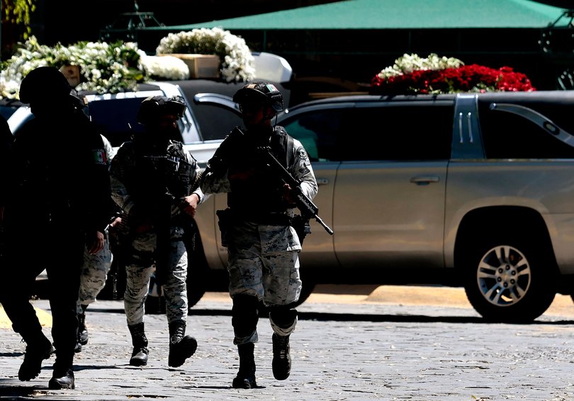 Mexican soldiers patrol the area as the hearse of drug trafficker Nemesio "El Mencho" Oseguera arrives at Recinto de la Paz cemetery in Zapopan.
