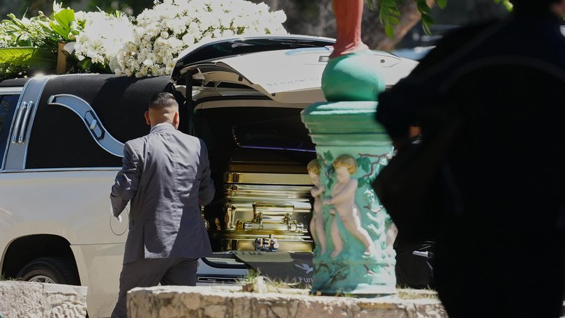 An employee opens the door of the car carrying carrying the remains of the late Jalisco New Generation Cartel leader Nemesio Oseguera, alias "El Mencho”.
