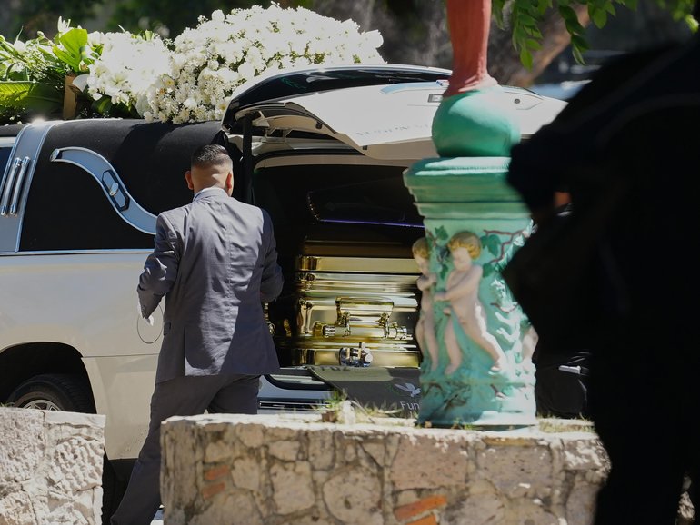 An employee opens the door of the car carrying carrying the remains of the late Jalisco New Generation Cartel leader Nemesio Oseguera, alias "El Mencho”.