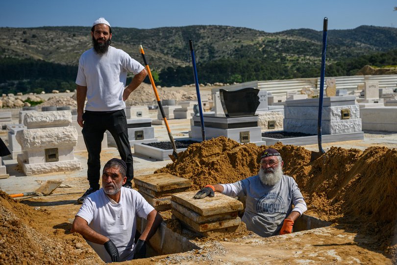 Grave workers wait in the gravesite for the bodies of Sara Elimelech and Ronit Elimelech, a mother and her adult daughter, killed in yesterday's Iranian missile strike on March 2, 2026 in Beit Shemesh, Israel.