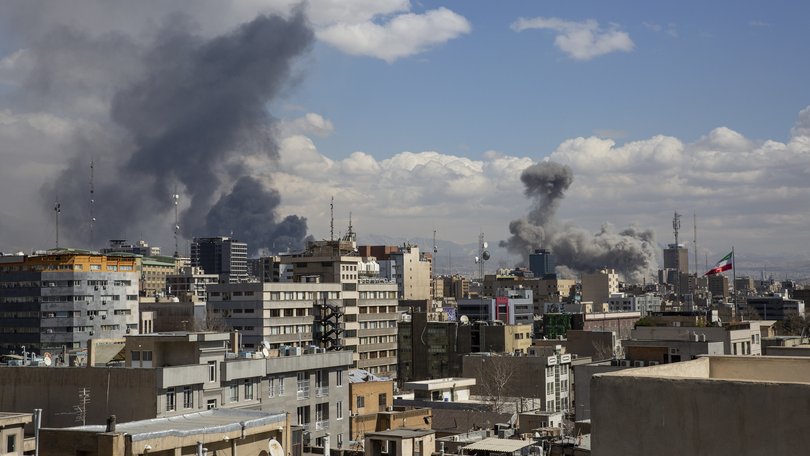 Smoke rises after US and Israeli airstrikes in Tehran.