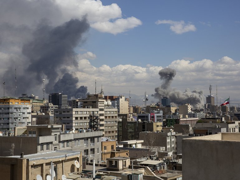 Smoke rises after US and Israeli airstrikes in Tehran.