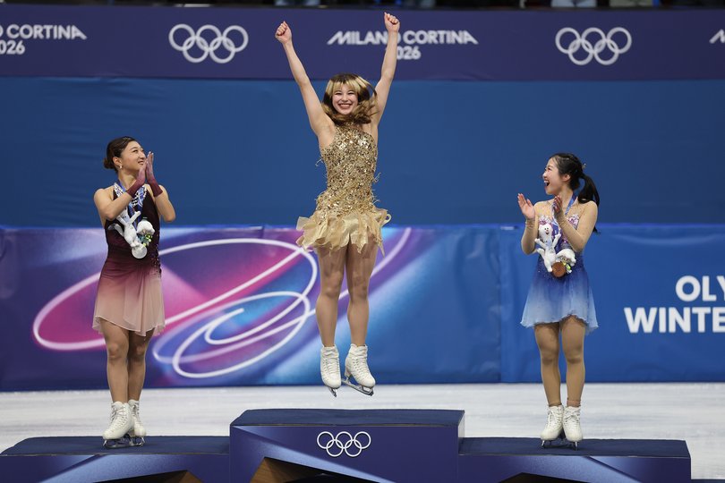 Gold medalist Alysa Liu of Team United States, silver medalist Kaori Sakamoto of Team Japan and bronze medalist Ami Nakai of Team Japan celebrate on the podium during the medal ceremony for the Women's Single Skating.