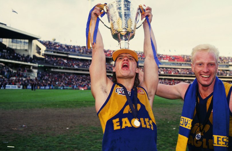 Glen Jakovich and Karl Langdon of the Eagles celebrate with the Premiership Cup after winning the 1992 AFL Grand Final between the West Coast Eagles and the Geelong Cats at the Melbourne Cricket Ground.