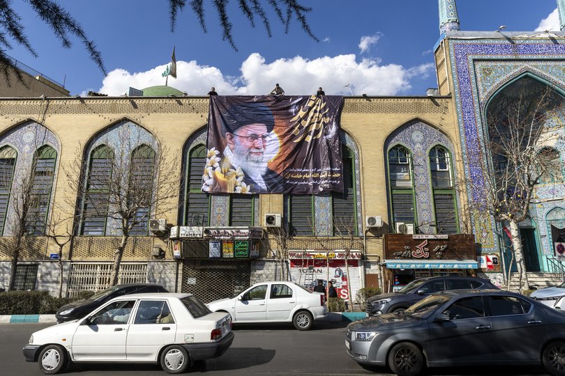 A giant poster featuring an image of Ayatollah Ali Khamenei is unfurled on a building on Thrusday.