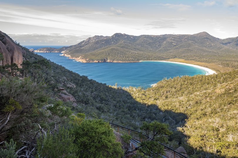 Overlooking Wineglass bay, a beach which, together with surrounding land formation, resembles a wine glass, in the Freycinet National park, Tasmania. The beach is one of Tasmania's biggest tourist attractions. 