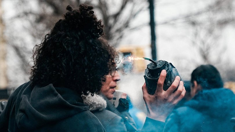 A man throws a hand-made explosive at supporters of US President Trump during a rally to stop public Muslim prayer, in New York City on Saturday.