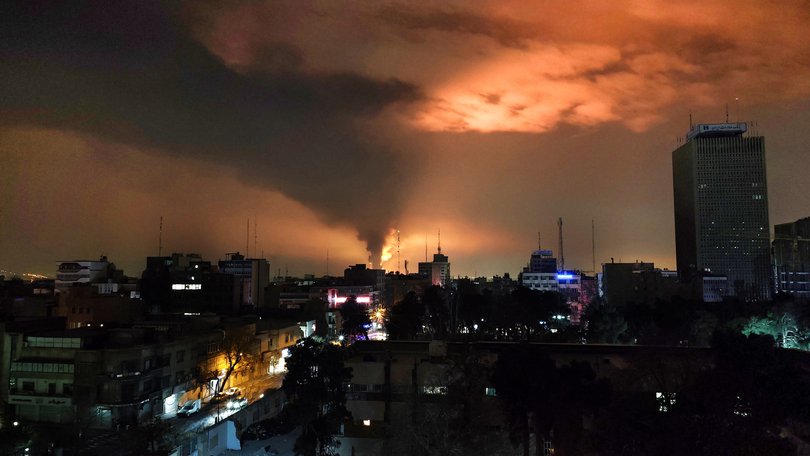 Smoke and flames rise after an airstrike on Tehran.