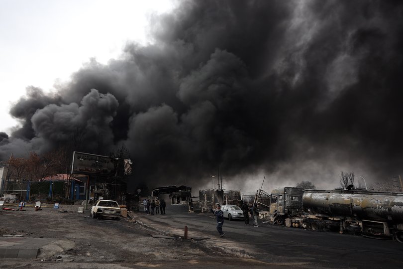 A view of the Main gate to the Shahran Oil Refinery as smoke still rises following the air strikes.