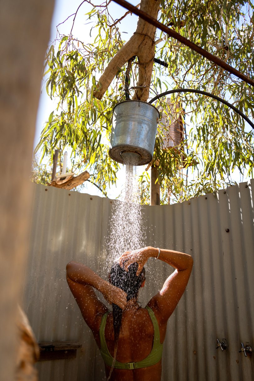 Guest using outdoor shower at Bullara Station Stay, Exmouth Picture: Olivia Trinka