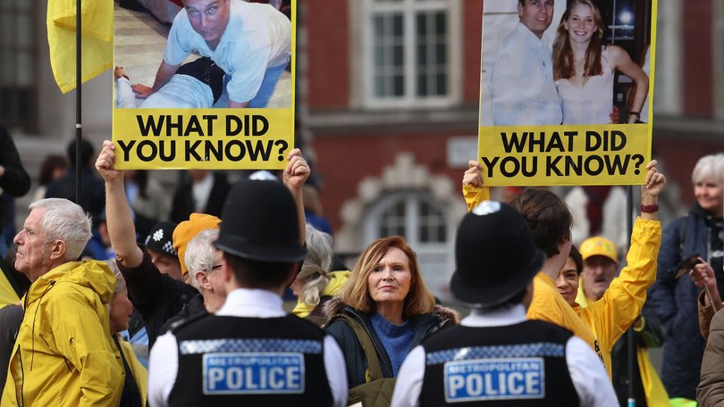 Anti-royal protesters holding placards showing images of Andrew Mountbatten-Windsor demonstrate ahead of the Commonwealth Service at Westminster Abbey in London.