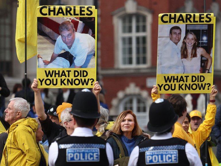 Anti-royal protesters holding placards showing images of Andrew Mountbatten-Windsor demonstrate ahead of the Commonwealth Service at Westminster Abbey in London.