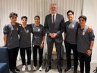 Tony Burke with five women from the Iranian women’s soccer team who have been granted asylum in Australia.