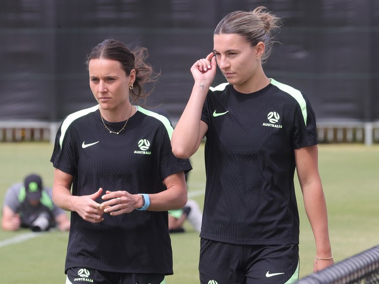 Hayley Raso and Steph Catley walk laps during training on Thursday.