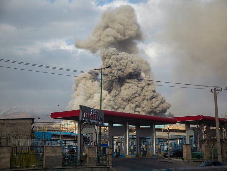 A plume of smoke rises after an explosion in Tehran.