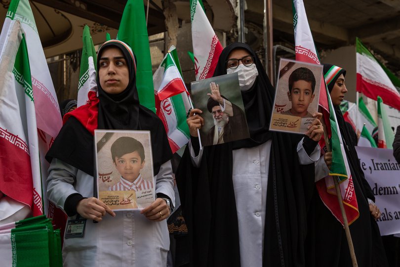 Holding photos of schoolchildren killed in Minab, Iranian healthcare workers demonstrate outside the Gandhi Hospital in Tehran on Saturday, March 7, 2026. An ongoing military investigation has determined that the United States is responsible for a deadly Tomahawk missile strike on an Iranian elementary school, according to U.S. officials and others familiar with the preliminary findings. (Arash Khamooshi/The New York Times)