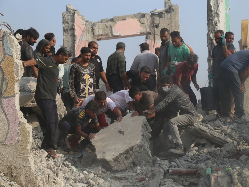 Rescue workers and residents search through the rubble in the aftermath of an Israeli-US strike on a girls' elementary school in Minab.