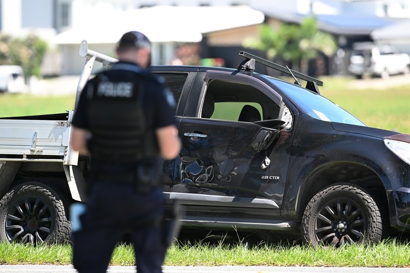 Police are seen near a damaged ute on Beaudesert Beenleigh Road.