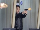 North Korean leader Kim Jong Un's daughter Kim Ju Ae test-firing a new pistol at a shooting gallery.