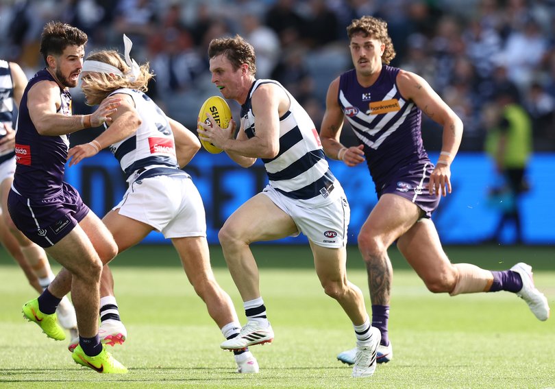 Max Holmes of the Cats runs with the ball.