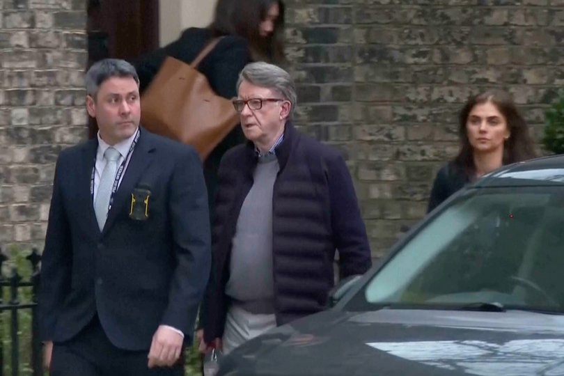 Peter Mandelson, center, escorted by police last month.