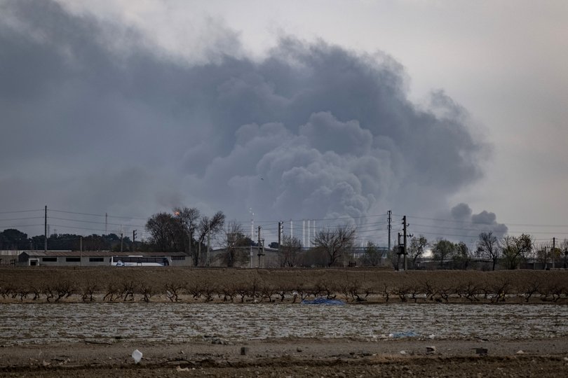 The sky is darkened by oil-soot residue from Tehran's petroleum storage facilities, which are struck during a US-Israeli military campaign in Tehran, Iran, on March 9, 2026. 