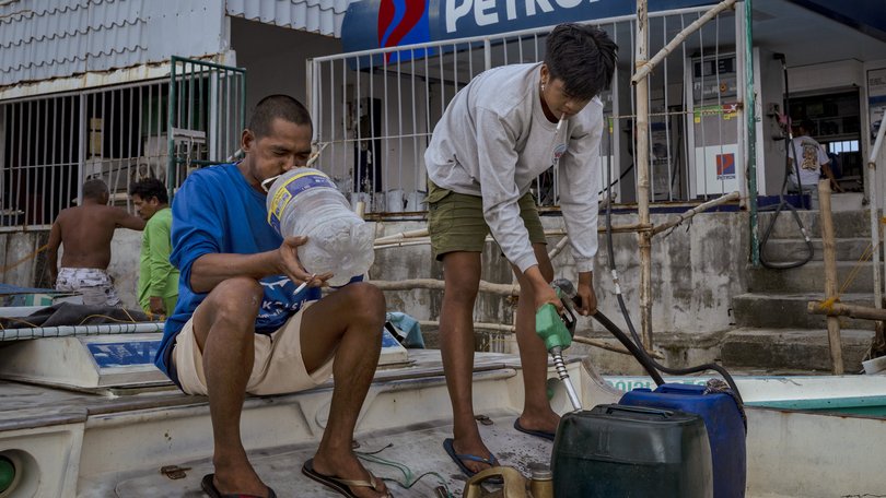 Fishermen buy fuel at a riverside gas station a day before a major fuel price surge  in Hagonoy, Bulacan province, Philippines. 