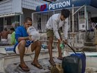 Fishermen buy fuel at a riverside gas station a day before a major fuel price surge  in Hagonoy, Bulacan province, Philippines. 