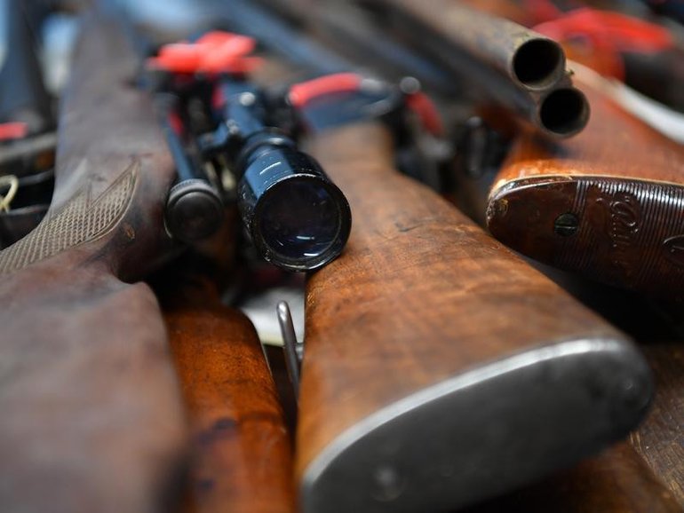 Police seized multiple guns after a group hunting trip on a remote property ended in a man's death. 