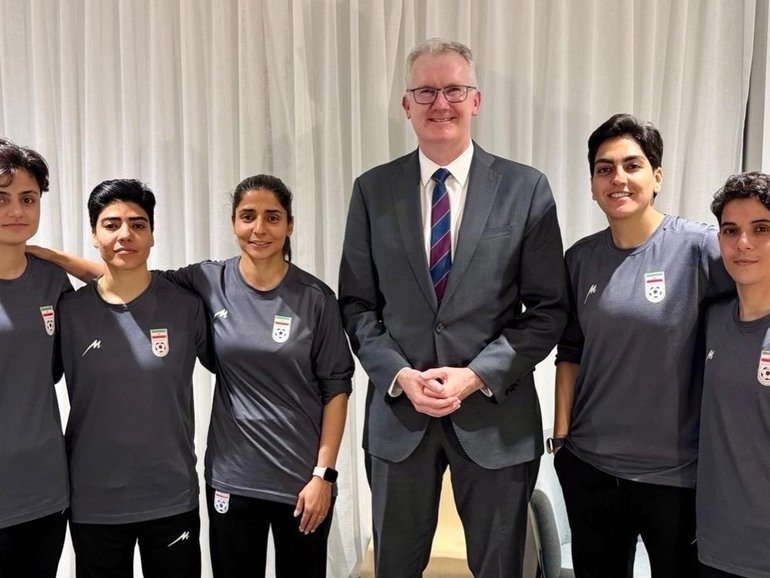 Home Affairs Minister Tony Burke with members of the Iranian women’s soccer team who had initially sought asylum. 