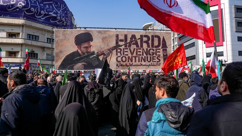 A banner depicting Ayatollah Mojtaba Khamenei at Enghelab (Revolution) Square in Tehran on March 11, 2026, as attendees gather for funerals of commanders from the Islamic Revolutionary Guard Corps.