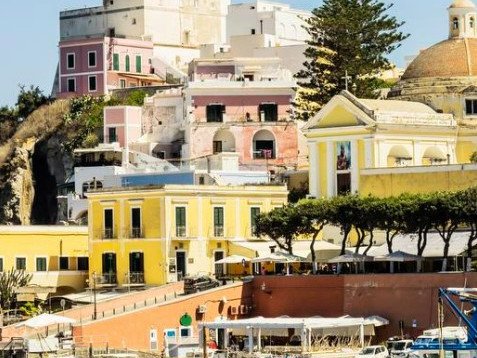 A pink Citroën Mehari climbs Ponza’s only road at dusk.