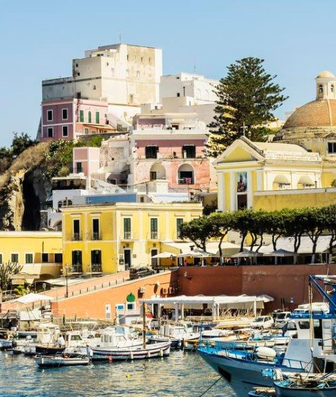 A pink Citroën Mehari climbs Ponza’s only road at dusk.