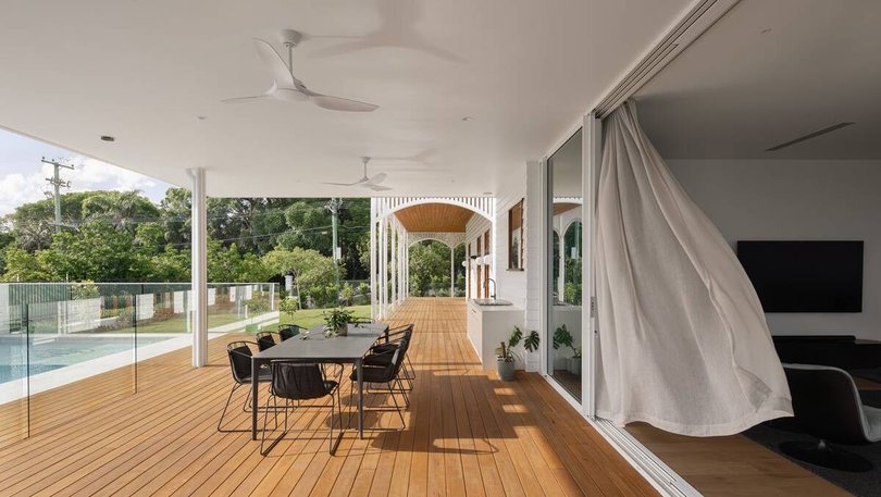 The kitchen flows out onto an outdoor deck with swimming pool. Pic: Ray White.