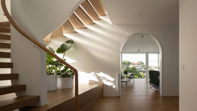 A scluptural staircase leads up to the main suite. Pic: Ray White.
