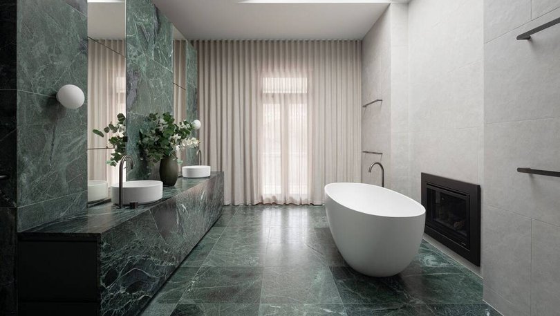 The main bedroom's en suite features a cosy fireplace next to the bathtub. Pic: Ray White.