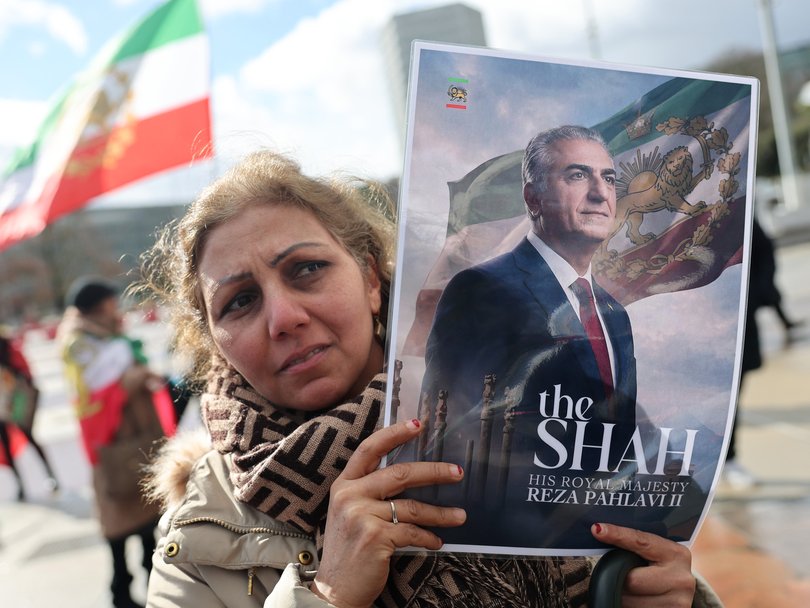 People gather with Iranian flags and posters in support of Reza Pahlavi, son of Mohammad Reza Pahlavi, the deposed Shah of Iran outside the United Nations headquarters in Geneva.