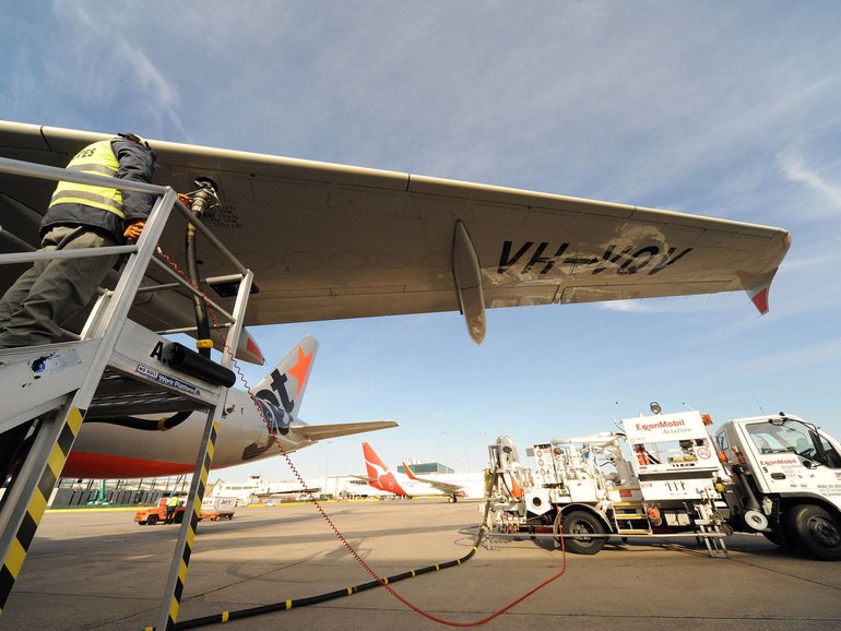 A Jetstar plane is refueled with Exxon Mobil fuel prior to take off, at Melbourne Airport.
