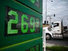 A petrol tanker reflected in a screen displaying the price of premium diesel pulls into a service station in Footscray, Melbourne, on Wednesday.