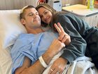 Jonathan Brown pictured with wife Kylie in hospital.