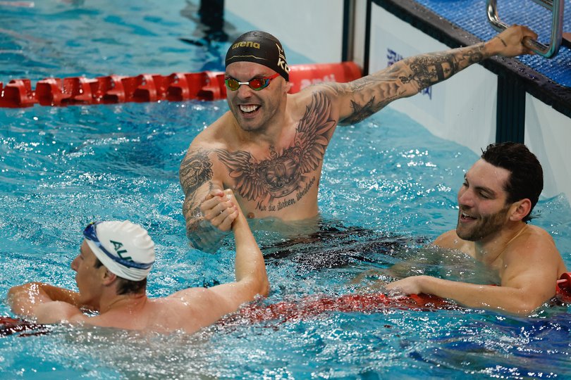 Cameron McEvoy of Australia celebrates with Kyle Chalmers of Australia and Jack Alexy of team United States after winning the gold medal in the Men's 50m Freestyle Final during day two of the China Open Swimming Championship.