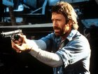 Chuck Norris points a gun in a scene from the film 'Hero And The Terror', 1988.