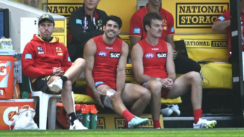 A strapped-up Christian Petracca watches from the bench as the Suns thrash the Tigers at the MCG.