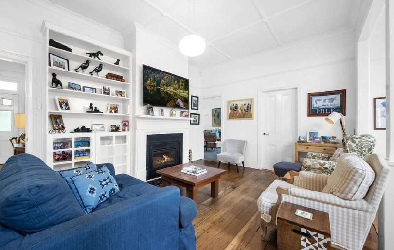 The property features soaring ceilings, Baltic Pine flooring, decorative mouldings and ceilings, as well as a picket fence for privacy.